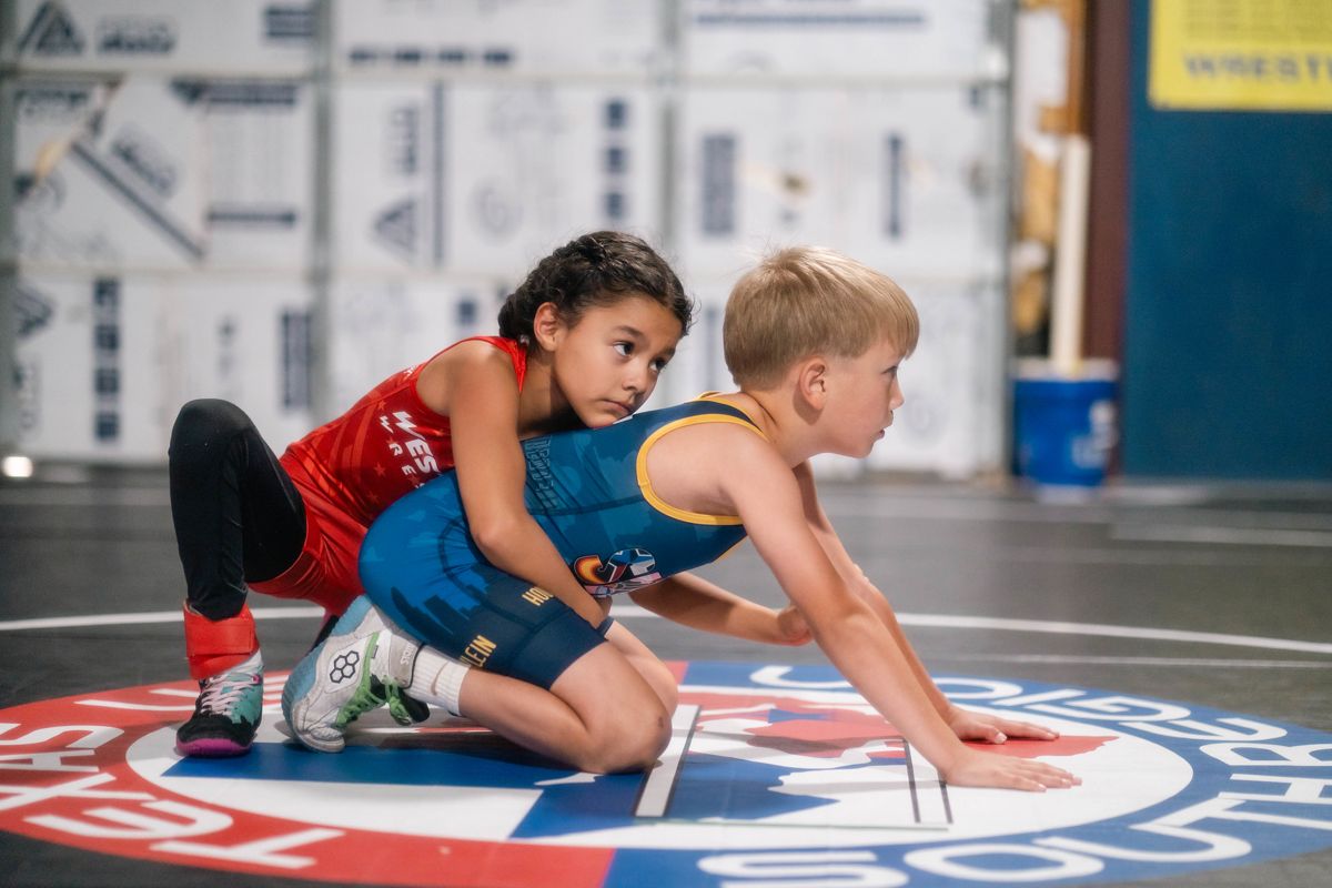 Two young wrestlers in a match on a Texas USA Wrestling mat